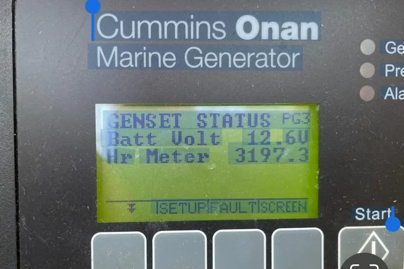 Mojito Yacht Photos Pics Cummins Onan marine generator display showing battery voltage and hour meter readings.