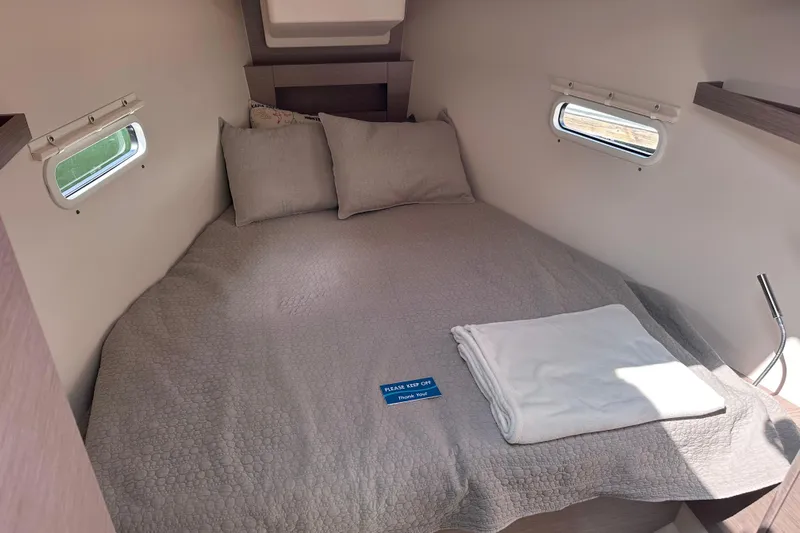 Mdr 388 #305 In Stock Yacht Photos Pics Cozy cabin interior of 2023 Hanse 388 yacht with comfortable bed and windows.