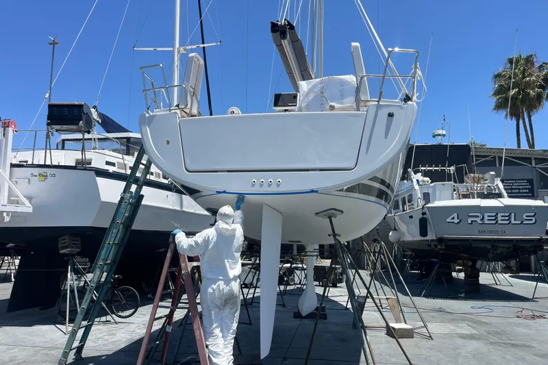 388 #305 Mdr Yacht Photos Pics Worker painting Hanse 388 sailboat in dry dock, 2023 model.