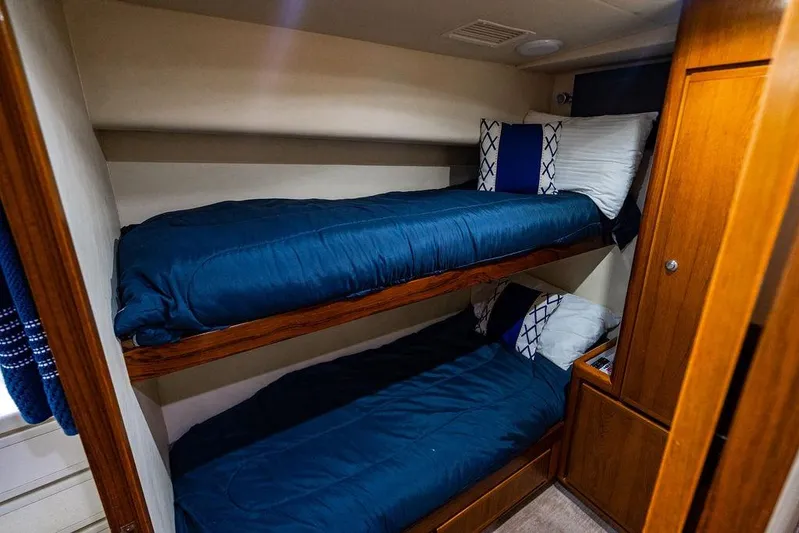 Energy Yacht Photos Pics Bunk beds in 1998 Bertram 60 Convertible yacht cabin with blue bedding.