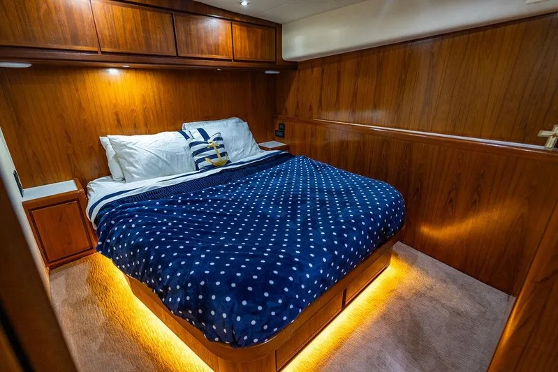 Energy Yacht Photos Pics Luxurious cabin interior of a 1998 Bertram 60 Convertible yacht with cozy bedding.