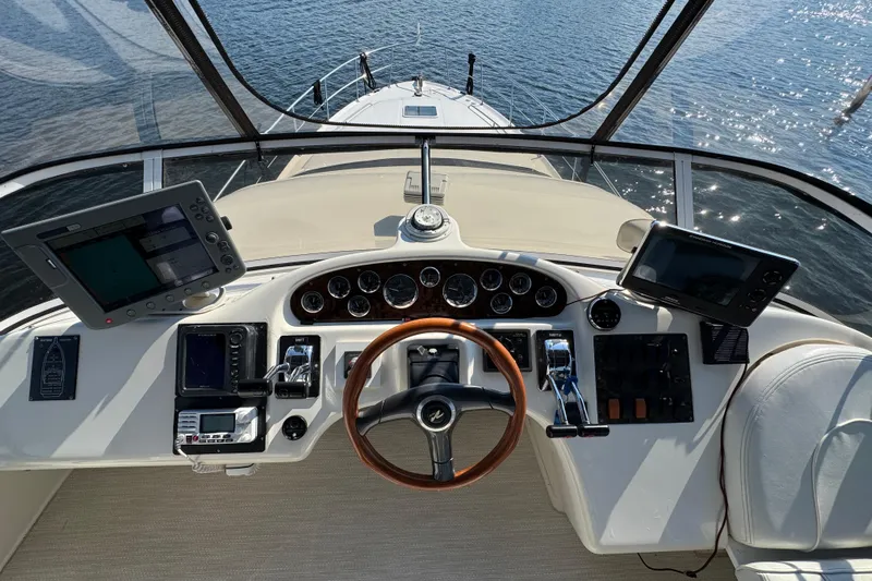 Shaneanigans Yacht Photos Pics Cockpit view of 1998 Sea Ray 400 Sedan Bridge with navigation equipment and steering wheel.