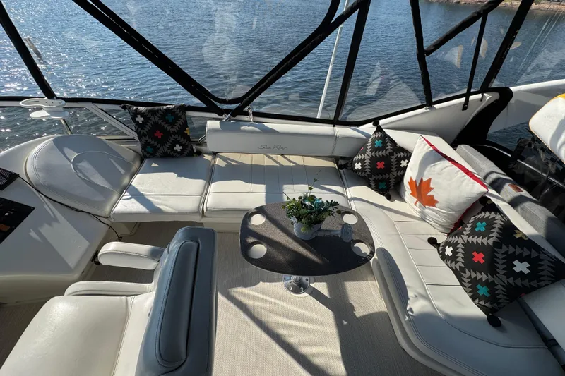 Shaneanigans Yacht Photos Pics Luxurious 1998 Sea Ray 400 Sedan Bridge interior with stylish seating and decorative pillows.
