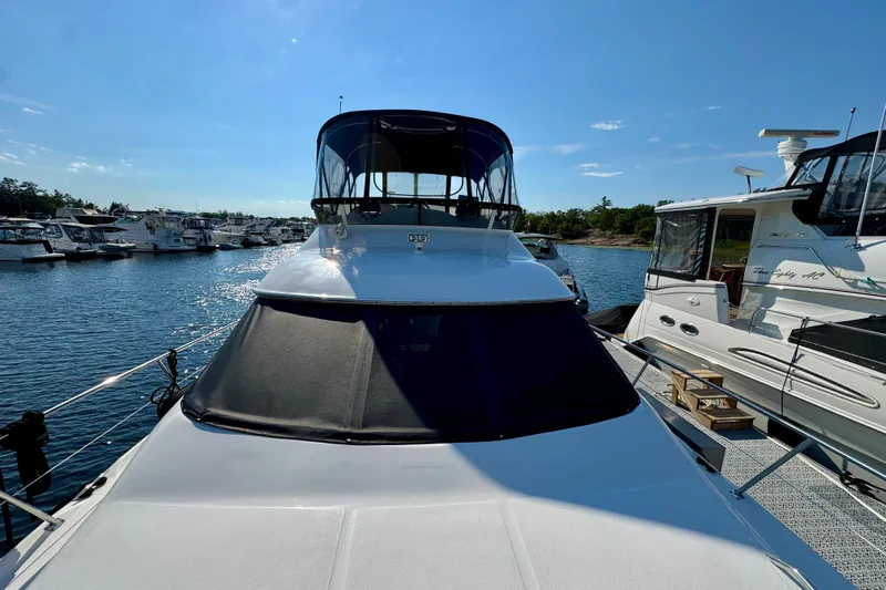 Shaneanigans Yacht Photos Pics 1998 Sea Ray 400 Sedan Bridge yacht docked at marina under clear blue sky.