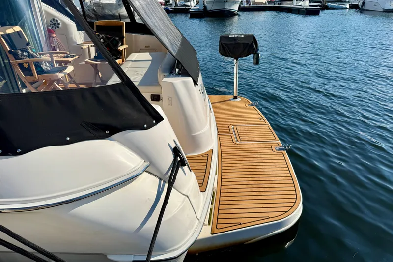 Shaneanigans Yacht Photos Pics 1998 Sea Ray 400 Sedan Bridge yacht with wooden deck at marina.