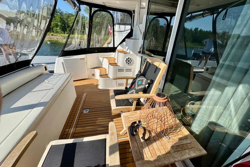 Shaneanigans Yacht Photos Pics 1998 Sea Ray 400 Sedan Bridge yacht interior with wooden deck and comfortable seating.