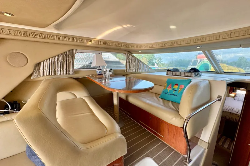 Shaneanigans Yacht Photos Pics Interior of 1998 Sea Ray 400 Sedan Bridge with cozy seating and dining area.