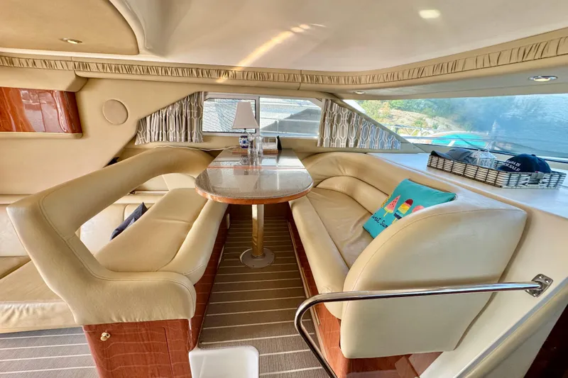 Shaneanigans Yacht Photos Pics Interior of 1998 Sea Ray 400 Sedan Bridge with elegant seating and dining area.