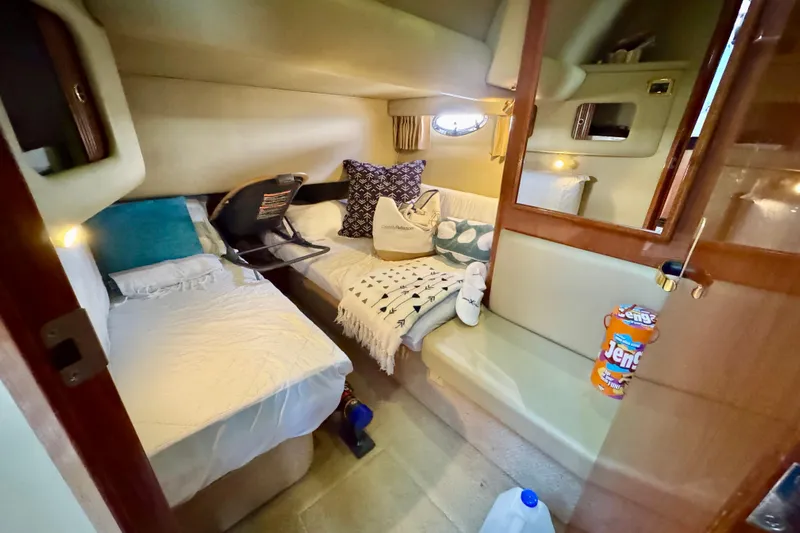 Shaneanigans Yacht Photos Pics 1998 Sea Ray 400 Sedan Bridge cabin interior with cozy beds and seating area.