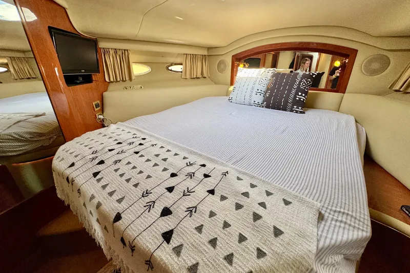 Shaneanigans Yacht Photos Pics Luxurious bedroom interior of 1998 Sea Ray 400 Sedan Bridge yacht with cozy bedding.