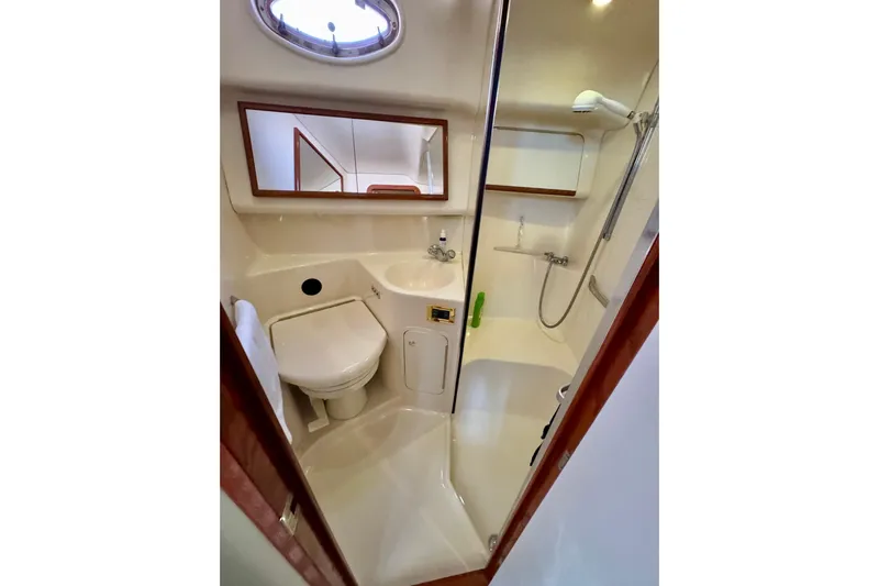 Shaneanigans Yacht Photos Pics 1998 Sea Ray 400 Sedan Bridge bathroom with shower, sink, and toilet.