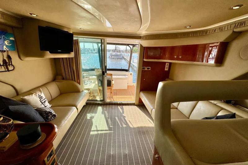 Shaneanigans Yacht Photos Pics Luxurious interior of a 1998 Sea Ray 400 Sedan Bridge yacht with waterfront view.