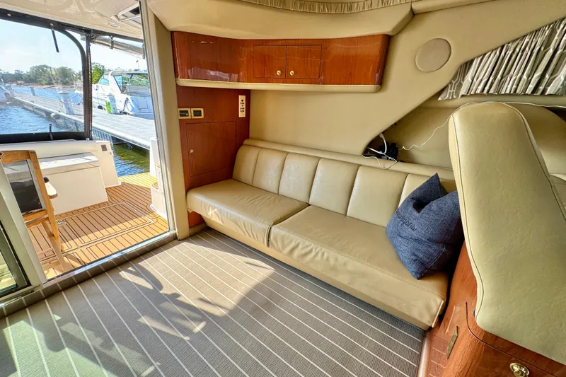 Shaneanigans Yacht Photos Pics Interior of 1998 Sea Ray 400 Sedan Bridge with beige leather seating and wooden accents.