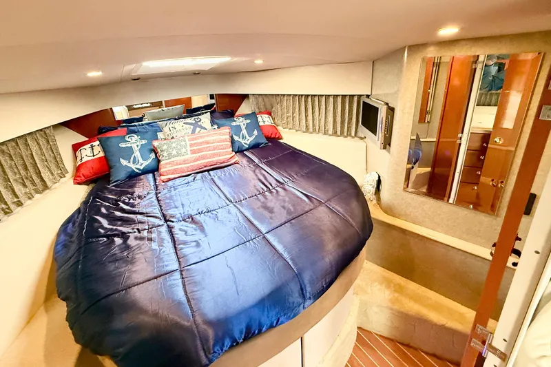 Yachtsea Yacht Photos Pics Luxurious 2004 Formula 40 Performance Cruiser cabin with nautical-themed bedding.