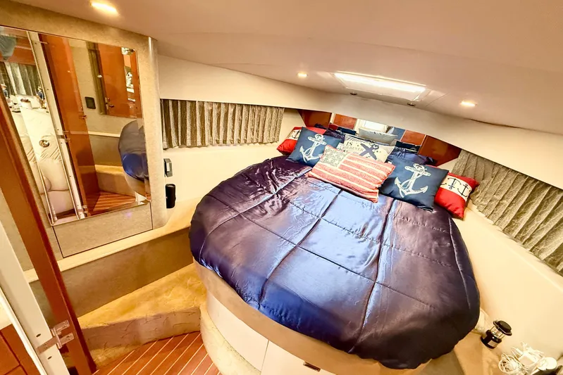 Yachtsea Yacht Photos Pics Luxurious 2004 Formula 40 Performance Cruiser cabin with nautical-themed bedding.