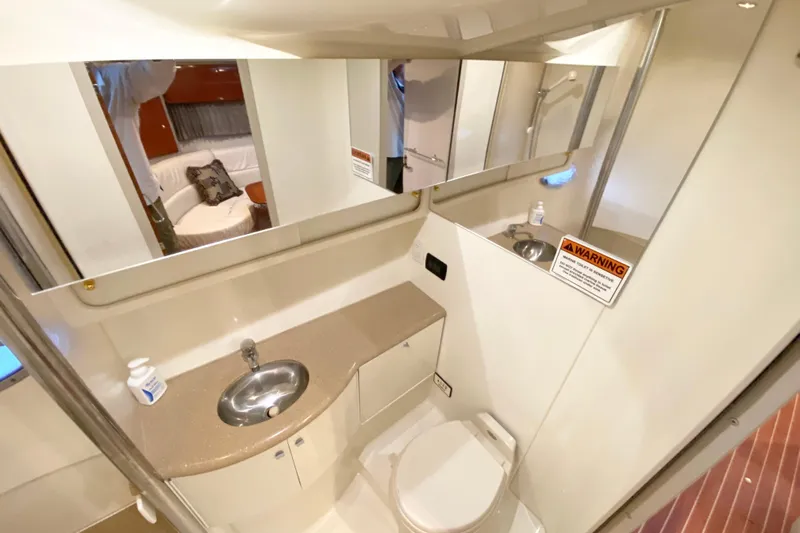 Yachtsea Yacht Photos Pics 2004 Formula 40 Performance Cruiser bathroom with sink, toilet, and mirror.
