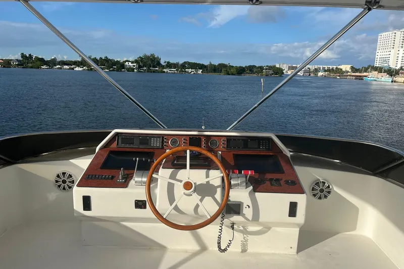 Atlantis Yacht Photos Pics Helm of 1996 Hershine Benship 87 yacht with scenic water view.