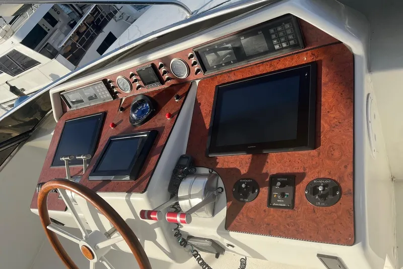 Atlantis Yacht Photos Pics Control panel of a 1996 Hershine Benship 87 yacht with navigation screens and instruments.