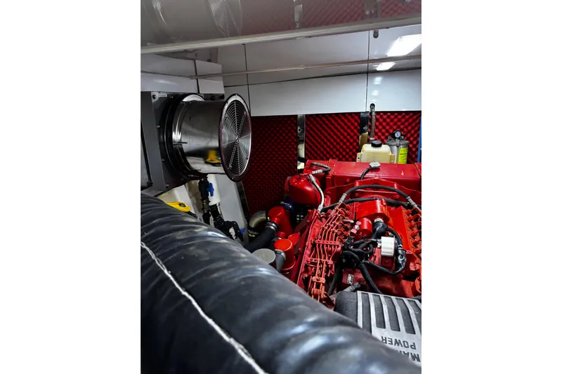Atlantis Yacht Photos Pics Engine room of 1996 Hershine Benship 87 yacht with red machinery and ventilation system.