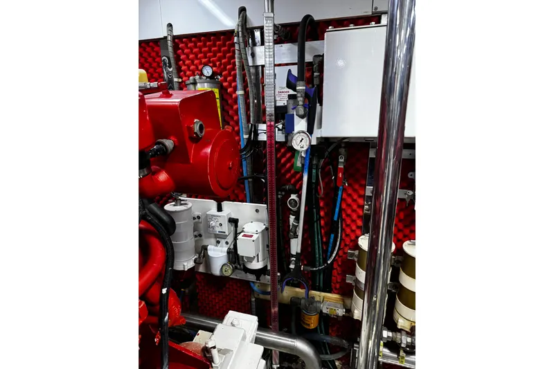 Atlantis Yacht Photos Pics Engine room of 1996 Hershine Benship 87 with red machinery and gauges.