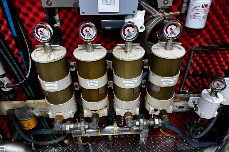Atlantis Yacht Photos Pics Engine room of 1996 Hershine Benship 87 with fuel filters and pressure gauges.