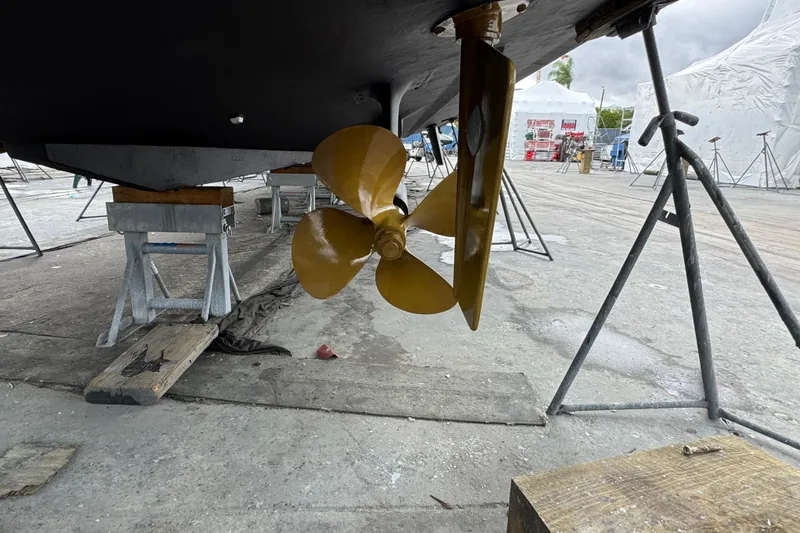 Atlantis Yacht Photos Pics Propeller of 1996 Hershine Benship 87 on dry dock, supported by stands.
