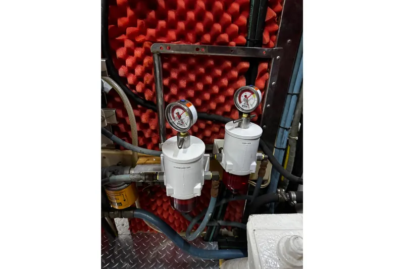 Atlantis Yacht Photos Pics Engine room of 1996 Hershine Benship 87 with fuel filters and pressure gauges.