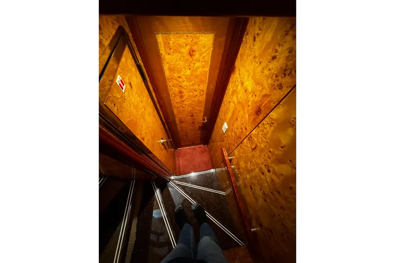 Atlantis Yacht Photos Pics Staircase with wooden paneling inside 1996 Hershine Benship 87 yacht.
