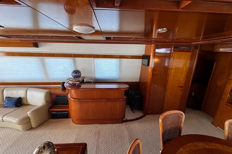 Atlantis Yacht Photos Pics Luxurious interior of 1996 Hershine Benship 87 yacht with elegant wood finishes.