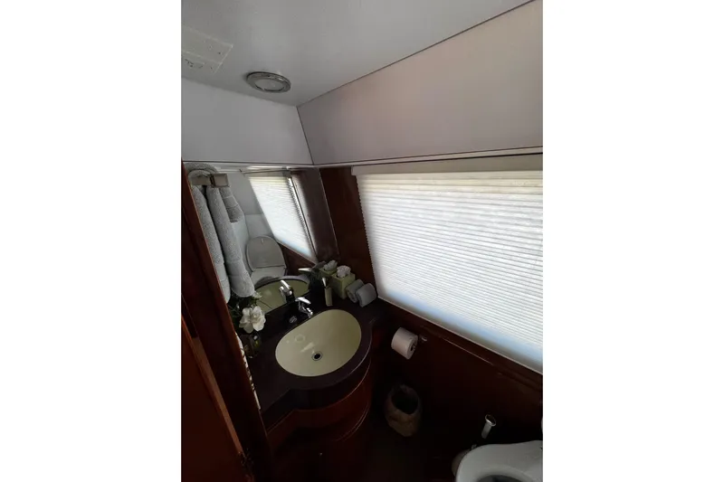 Atlantis Yacht Photos Pics Bathroom interior of 1996 Hershine Benship 87 yacht with sink and window blinds.