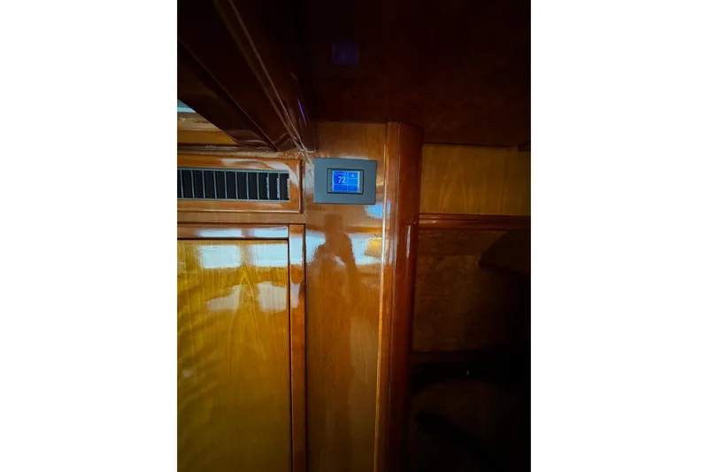 Atlantis Yacht Photos Pics Interior of 1996 Hershine Benship 87 yacht with wooden paneling and digital thermostat.