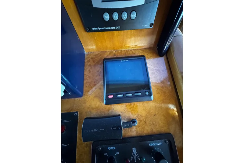 Atlantis Yacht Photos Pics Control panel of 1996 Hershine Benship 87 with Garmin display and system controls.