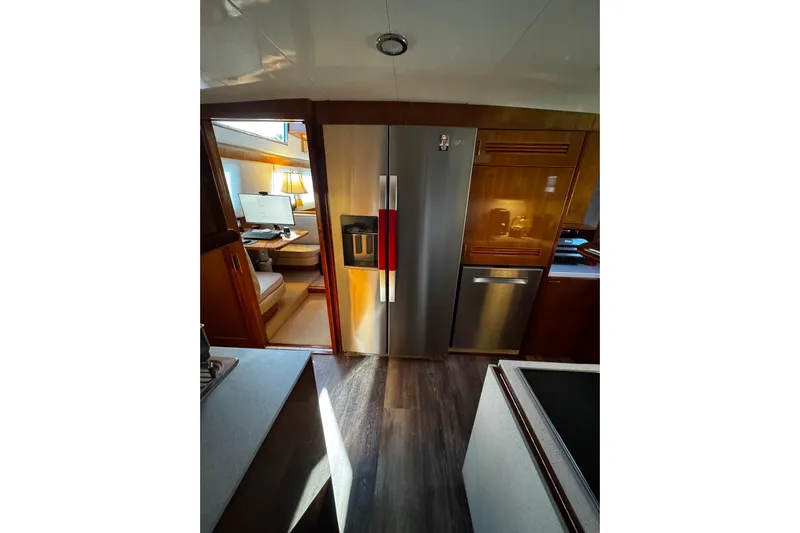 Atlantis Yacht Photos Pics Interior of 1996 Hershine Benship 87 yacht with modern kitchen and workspace.