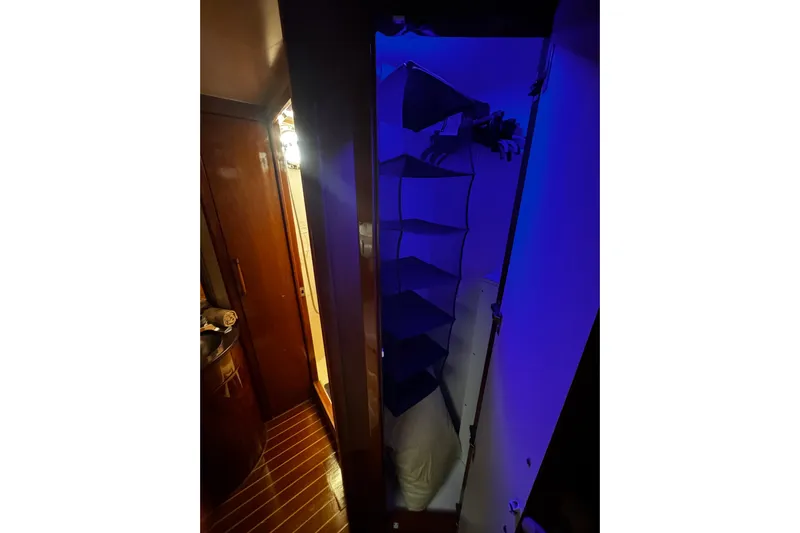 Atlantis Yacht Photos Pics Interior of 1996 Hershine Benship 87 yacht with illuminated closet and wooden flooring.