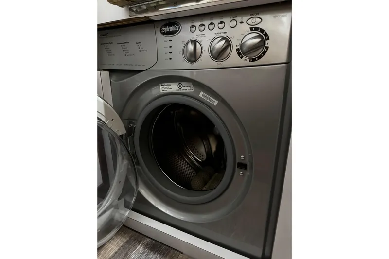 Atlantis Yacht Photos Pics Front-loading washing machine with open door, featuring control knobs and digital display.