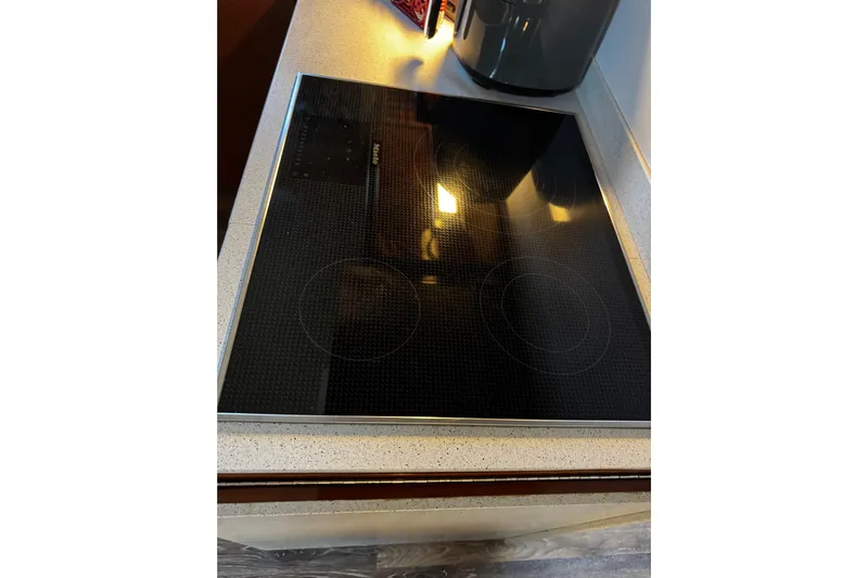 Atlantis Yacht Photos Pics Modern black glass cooktop on a Hershine Benship 87 yacht, 1996 model.