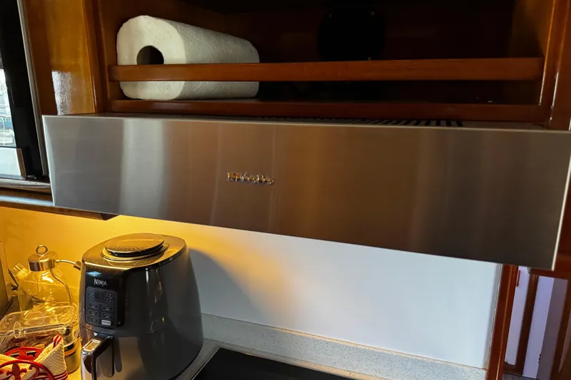 Atlantis Yacht Photos Pics Kitchen area in a 1996 Hershine Benship 87 yacht with modern appliances.