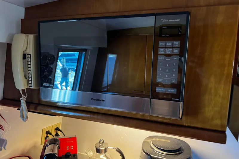 Atlantis Yacht Photos Pics Panasonic microwave and vintage phone in 1996 Hershine Benship 87 yacht kitchen.