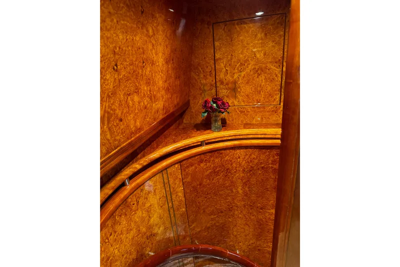 Atlantis Yacht Photos Pics Luxurious wood interior of 1996 Hershine Benship 87 yacht with elegant floral arrangement.