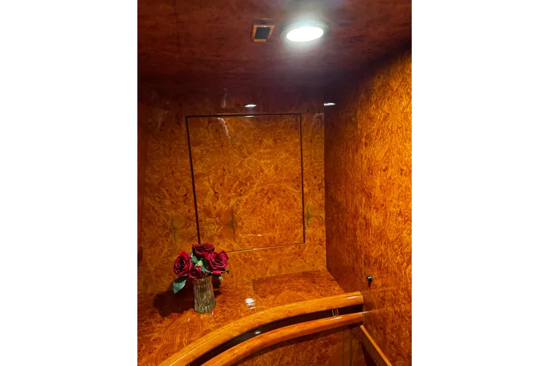 Atlantis Yacht Photos Pics Luxurious wood interior of 1996 Hershine Benship 87 yacht with roses in a vase.