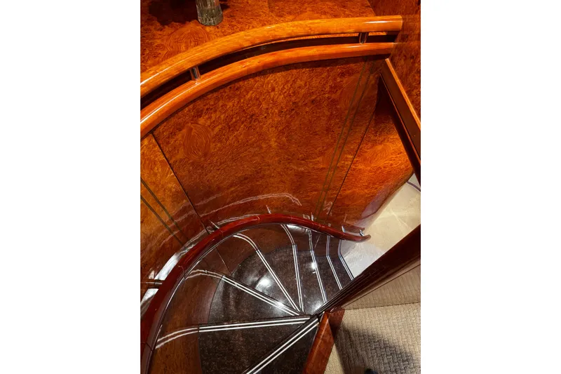 Atlantis Yacht Photos Pics Luxurious wooden spiral staircase on 1996 Hershine Benship 87 yacht.