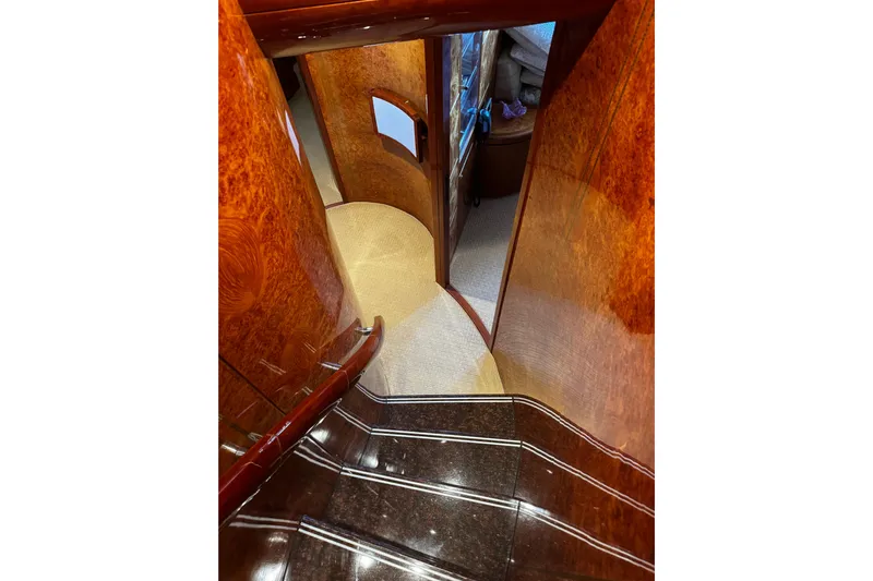 Atlantis Yacht Photos Pics Luxurious wooden staircase inside 1996 Hershine Benship 87 yacht, leading to lower cabin.
