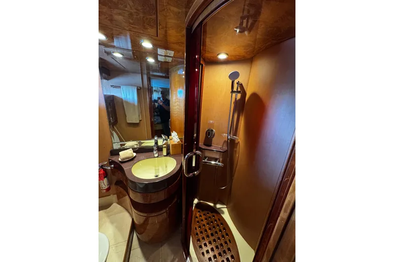 Atlantis Yacht Photos Pics Luxurious bathroom in 1996 Hershine Benship 87 yacht with modern fixtures and elegant wood finish.