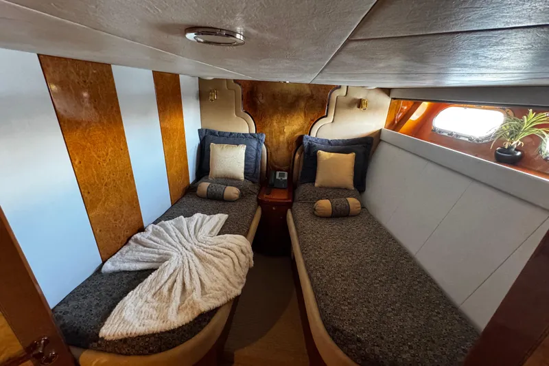 Atlantis Yacht Photos Pics Luxurious cabin interior of 1996 Hershine Benship 87 yacht with twin beds and elegant decor.