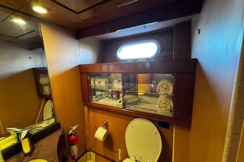 Atlantis Yacht Photos Pics Luxurious bathroom interior of 1996 Hershine Benship 87 yacht with wooden cabinetry.