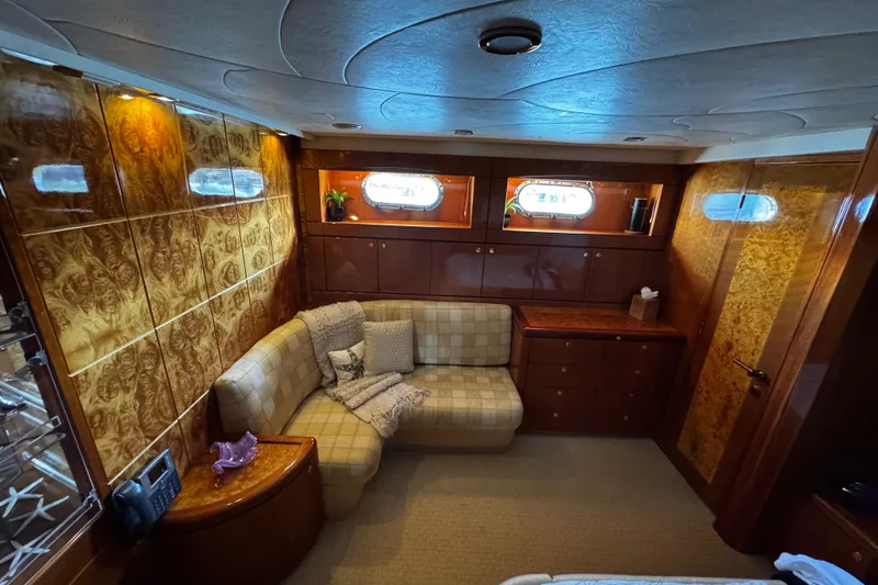 Atlantis Yacht Photos Pics Luxurious 1996 Hershine Benship 87 yacht interior with elegant wood paneling and cozy seating.