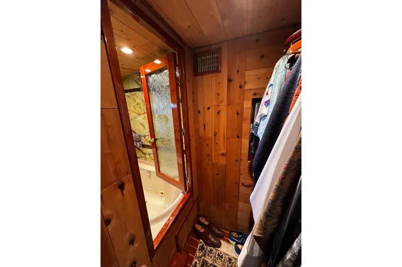 Atlantis Yacht Photos Pics Wood-paneled bathroom with jacuzzi tub on 1996 Hershine Benship 87 yacht.