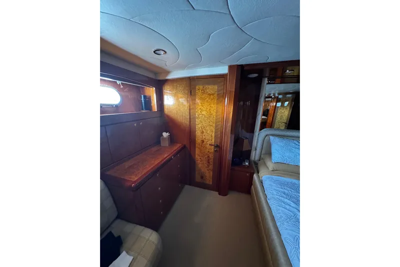 Atlantis Yacht Photos Pics Luxurious cabin interior of 1996 Hershine Benship 87 yacht with wood paneling.