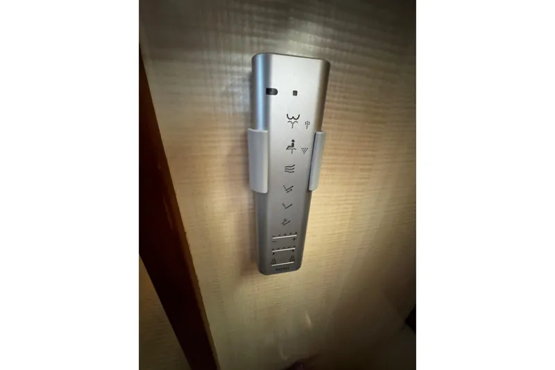 Atlantis Yacht Photos Pics Remote control mounted on a wall inside a 1996 Hershine Benship 87 yacht.