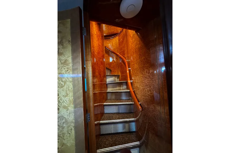 Atlantis Yacht Photos Pics Luxurious wooden staircase inside 1996 Hershine Benship 87 yacht, featuring elegant design.